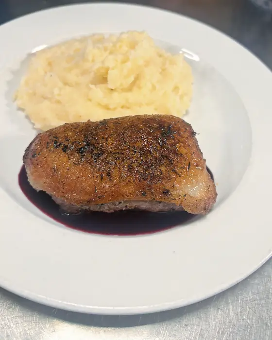 Duck breast over blackberry gin reduction