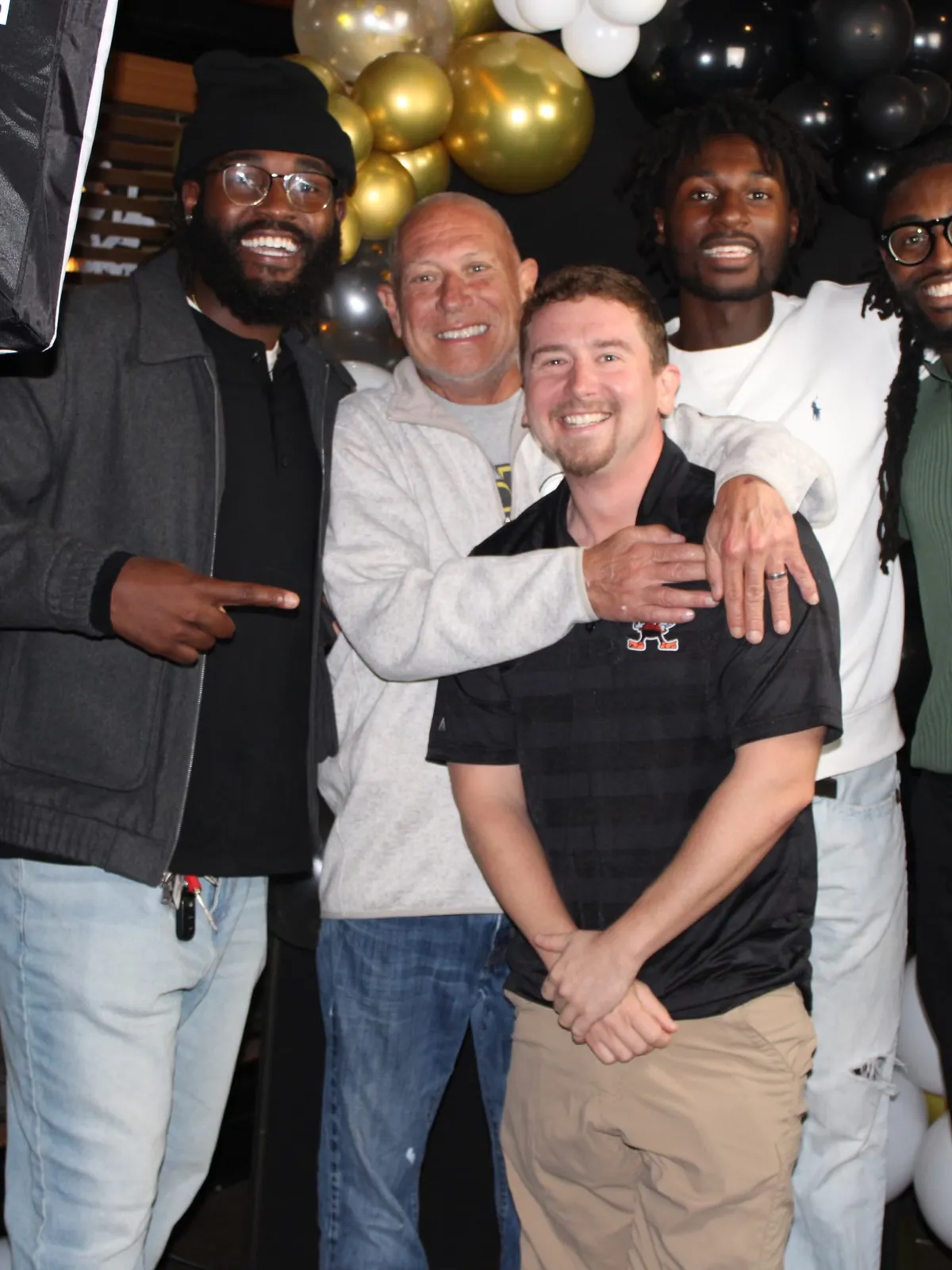 Bistro founder Rusty Chambers with his arm around Tony Paumier at a party